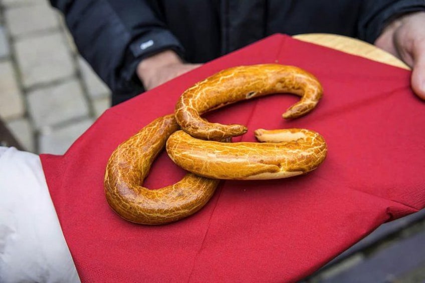 A large, curved sausage on a red cloth. 3