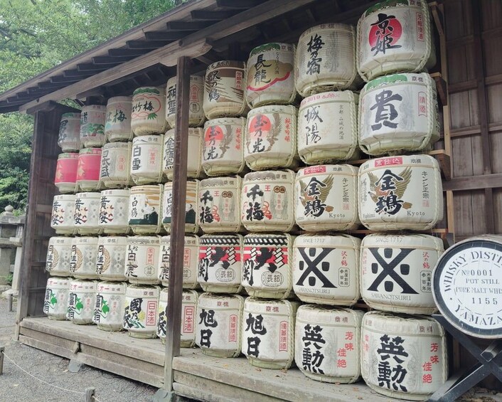 A wooden structure with large white containers stacked on shelves, each labeled with Japanese characters. 1