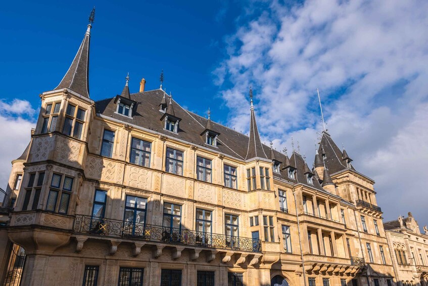A historic building with ornate architecture, including multiple spires and detailed stonework. 4