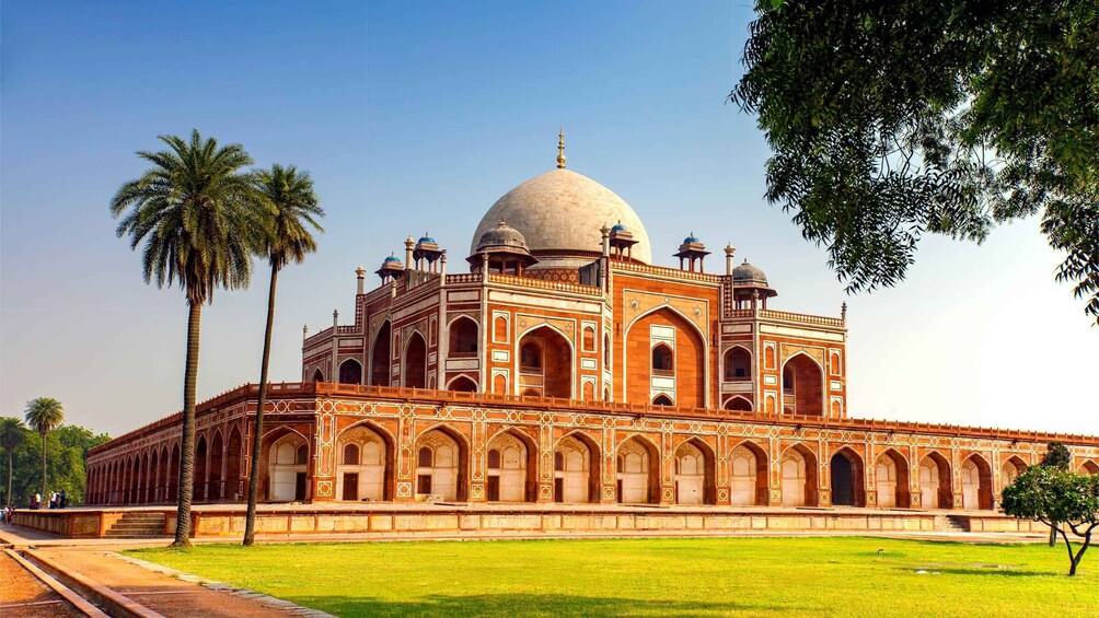 The Taj Mahal with its large central dome, four minarets, and surrounding gardens. 1