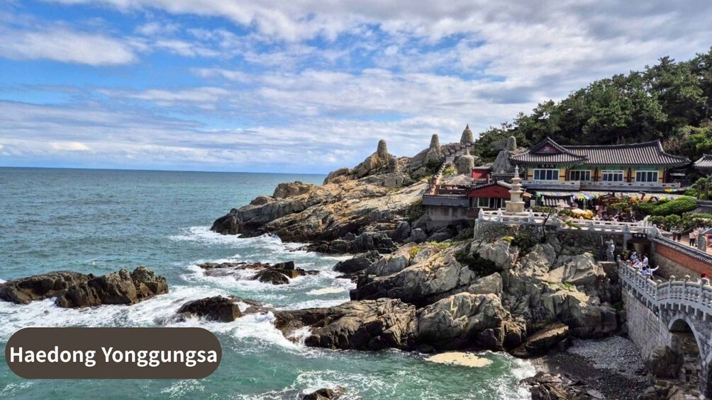 Haedong Yonggungsa temple complex by the sea, featuring rocky cliffs, traditional architecture, and a bridge. 1