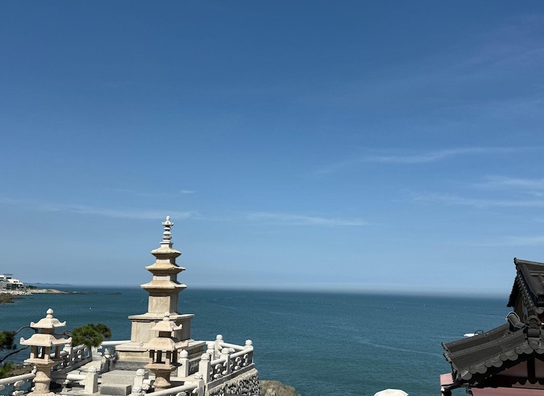 A pagoda with a tiered roof overlooking a coastal area. 5