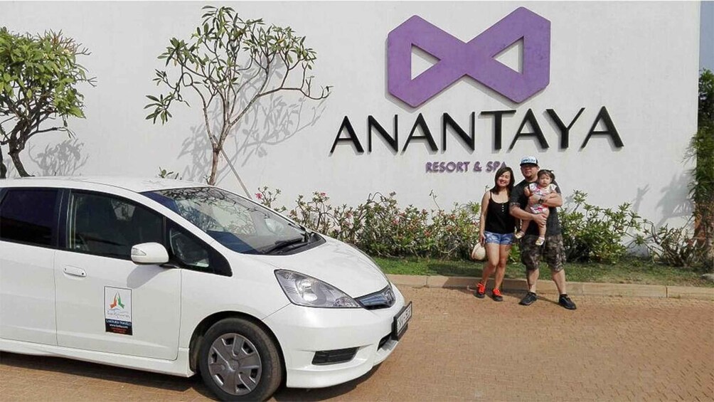 A white car parked in front of a sign for Anantaya Resort & Spa. 5