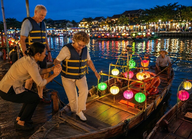 People boarding a traditional wooden boat with lanterns. 2