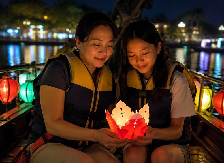 Two people sitting on a boat, holding a paper lantern. 4