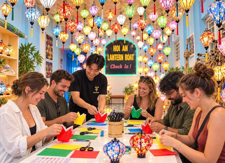 A group of people engaged in a lantern-making activity with a sign reading 'HOI AN LANTERN BOAT Check In!' 1
