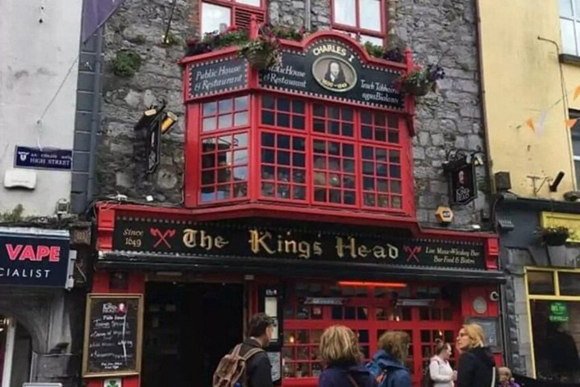 A red building with a sign that reads 'The King's Head.' 3
