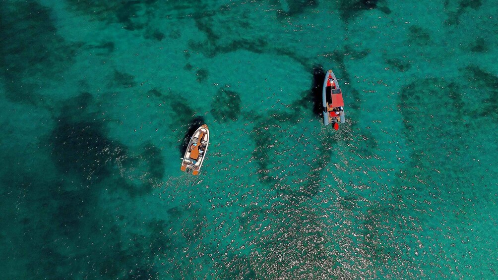 Two boats on clear turquoise water. 2