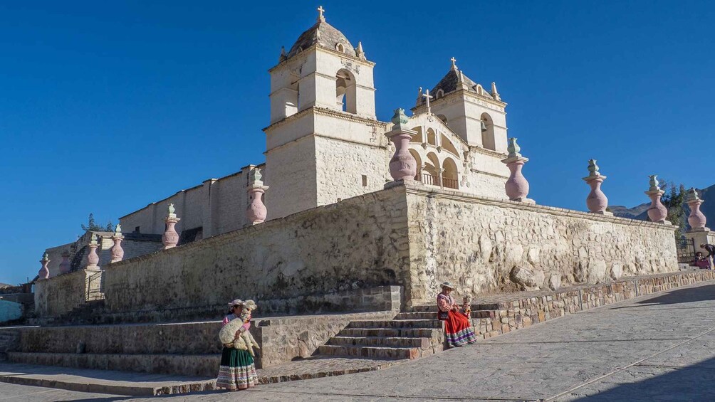 A historic church with a bell tower and statues on the facade. 5