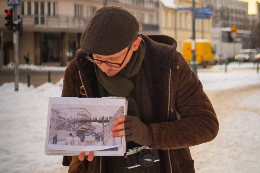 A person holding a book with a photograph on the cover. 3
