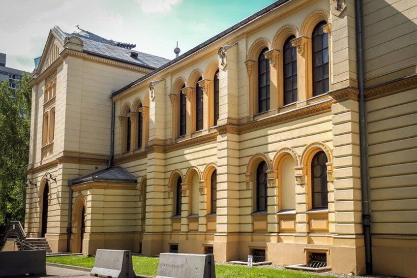 A classical building with arched windows and a symmetrical facade. 4