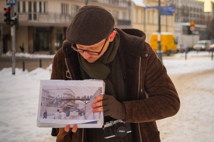 A person holding a book with a picture of a bridge. 3