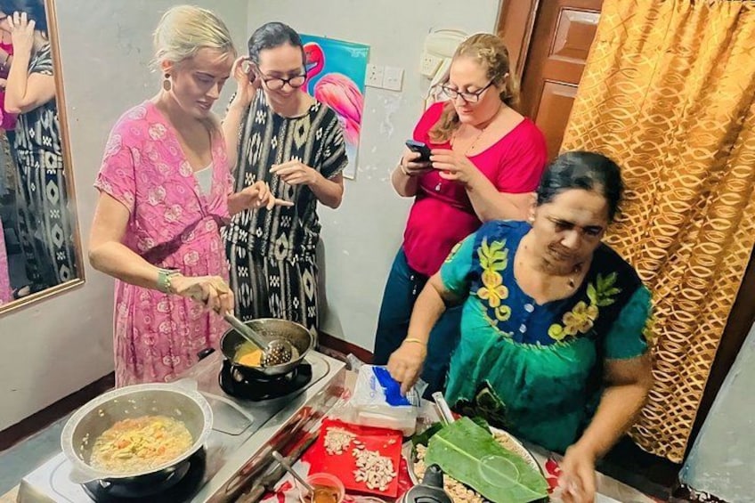 A group of people cooking together in a kitchen. 2