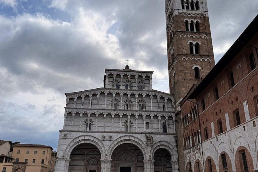 A historic building with a prominent bell tower and intricate facade. 2