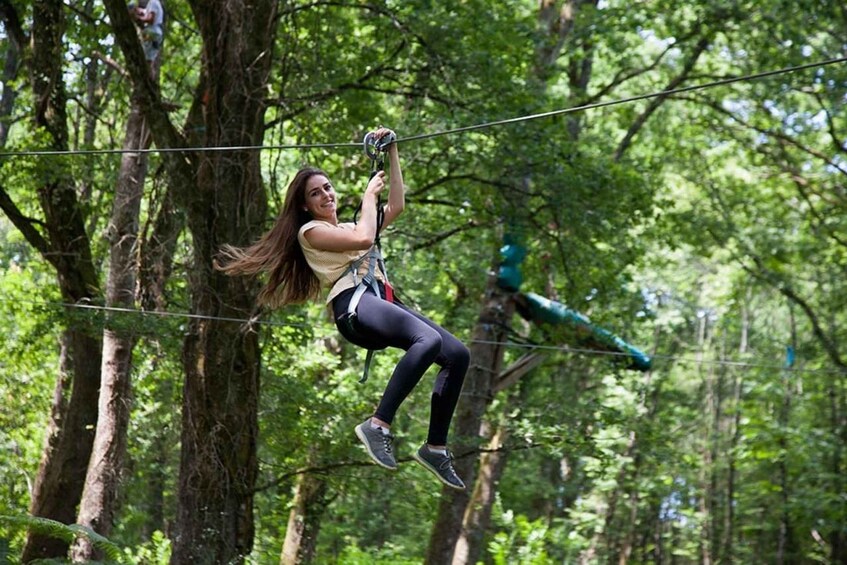 A person zip-lining through a forest. 5