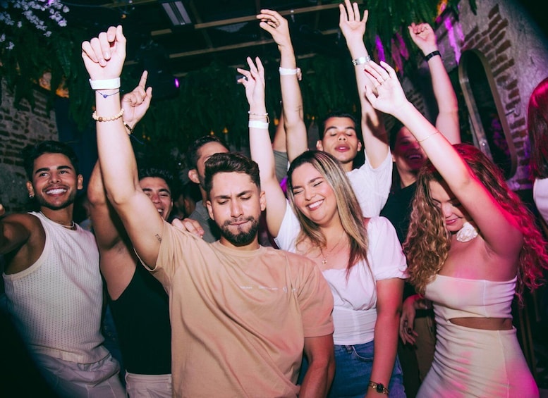 A group of people dancing at a party. 1