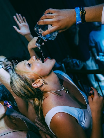 A person drinking water from a bottle. 4