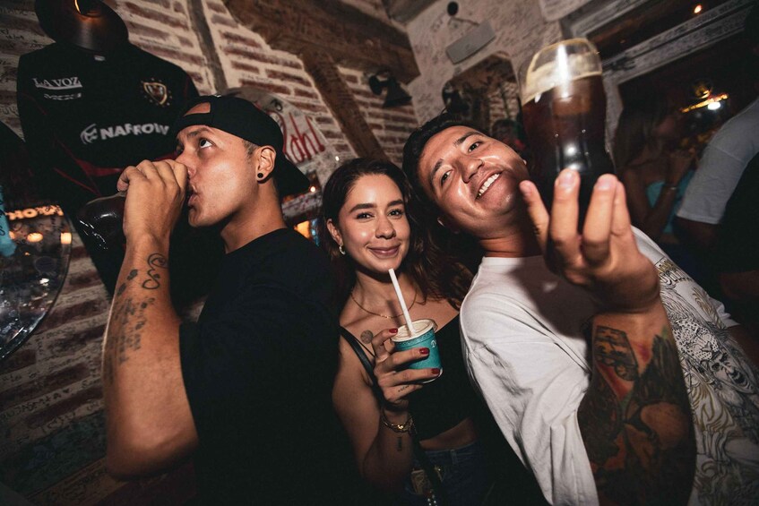 People in a bar with drinks and a brick wall background. 5