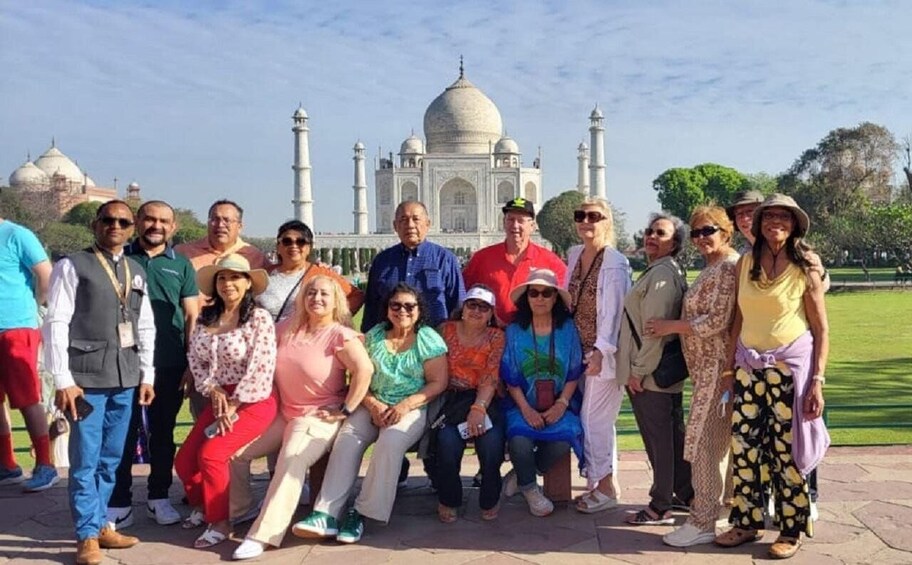 A group of people posing in front of the Taj Mahal. 5