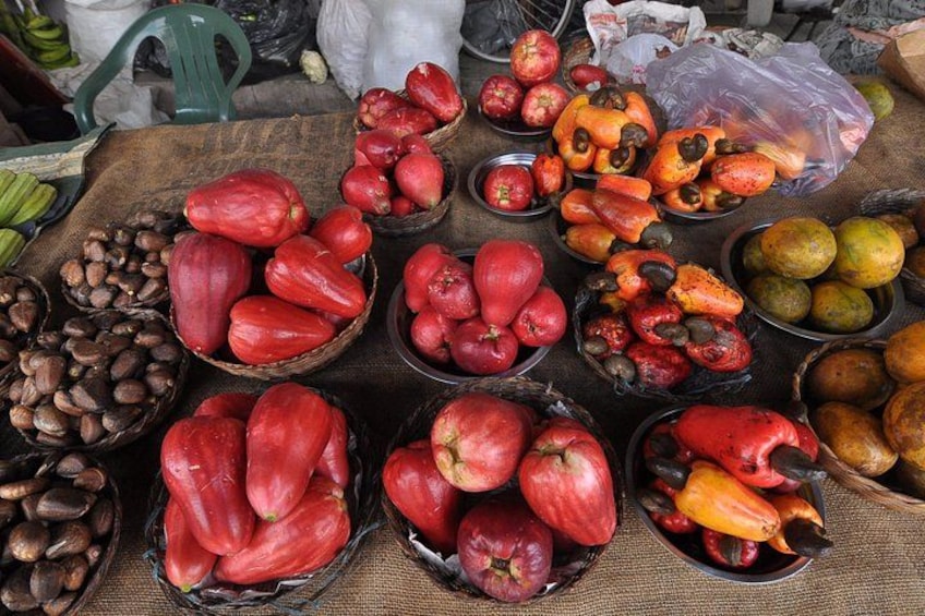 A variety of fruits and vegetables displayed in baskets at a market. 5