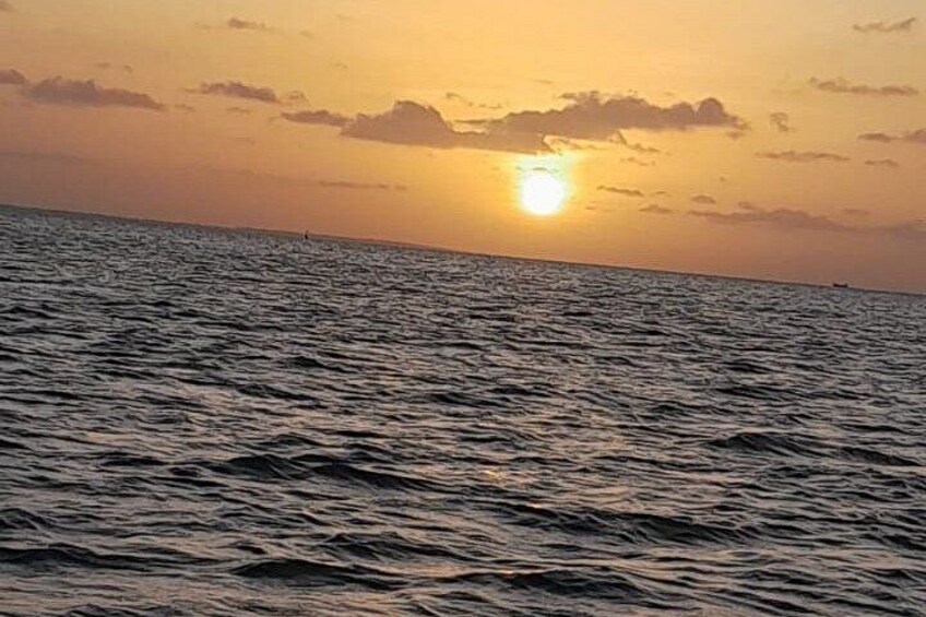 A sunset over the ocean with waves and a clear sky. 3