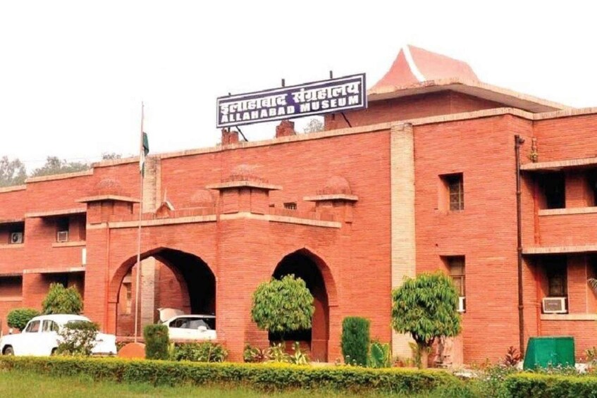A large brick building with a sign reading "Allahabad Museum". 1