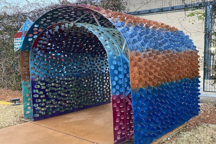A colorful, dome-shaped structure made of interlocking plastic pieces. 5