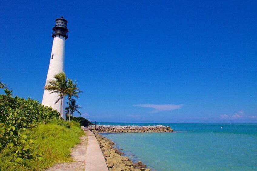 A lighthouse by the sea with a clear sky. 3