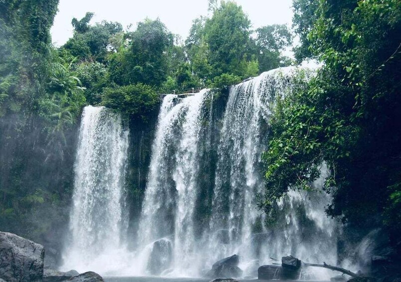 A multi-tiered waterfall surrounded by lush greenery. 5