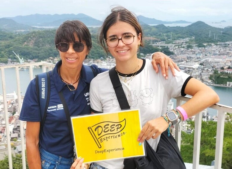 Two people holding a sign with the DeepExperience logo. 1
