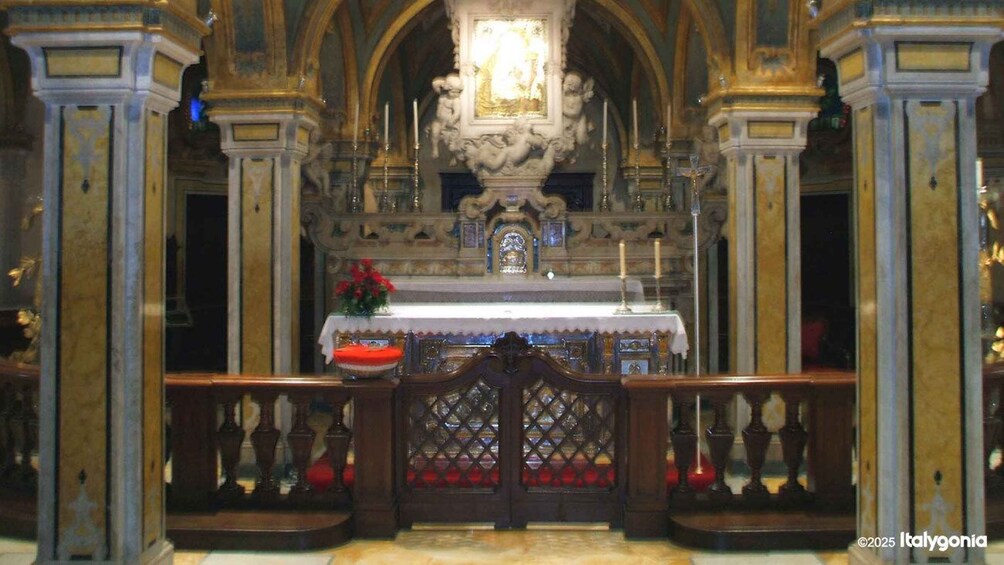 An ornate church interior with a central altar, ornate columns, and a decorative screen. 5