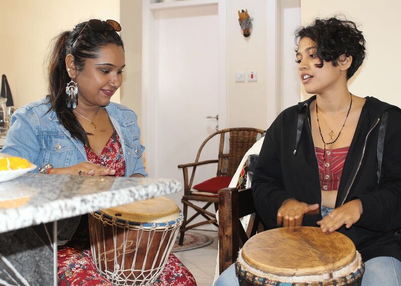 Two people playing drums at a table. 5