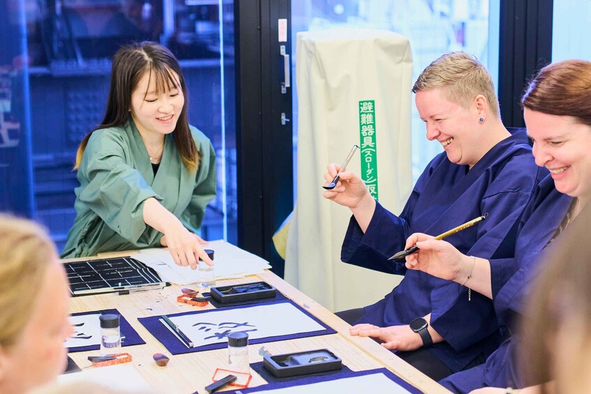 A group of people engaged in a workshop activity with tools and materials on a table. 1