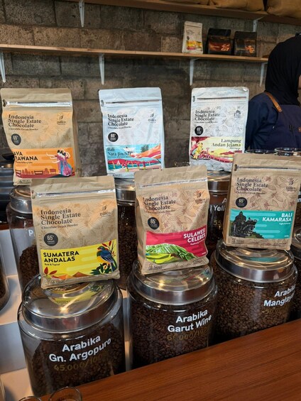 A display of coffee beans and chocolate drink powders at a store. 5