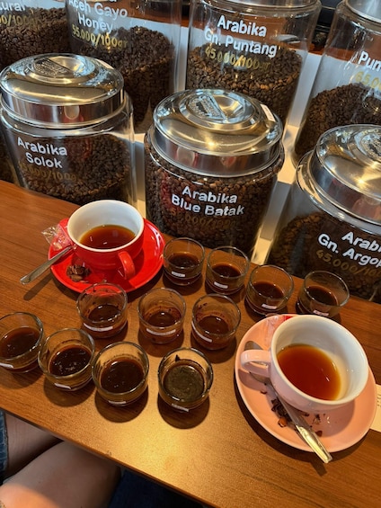 A coffee tasting setup with various coffee beans and cups of coffee. 3