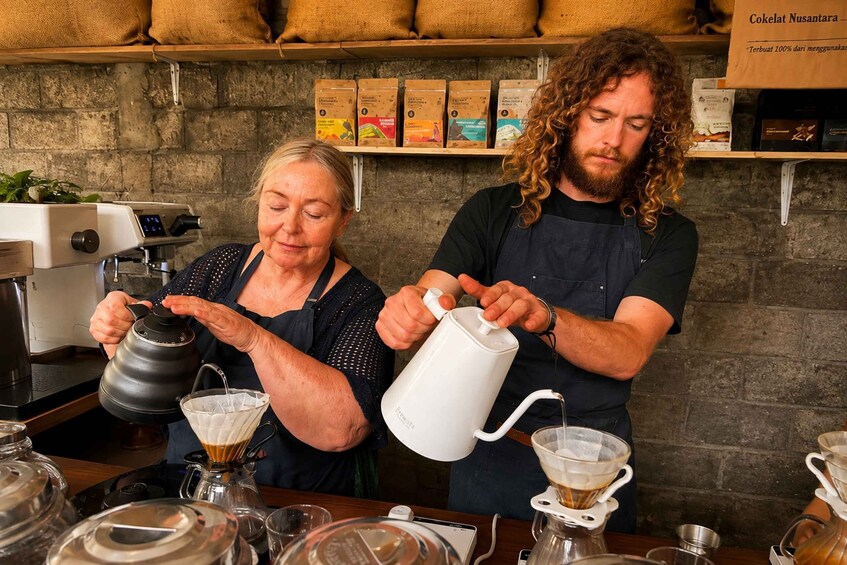 Two people preparing coffee in a cafe. 3