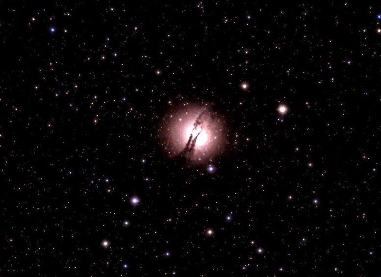 A starry night sky with a bright nebula and several visible stars. 4