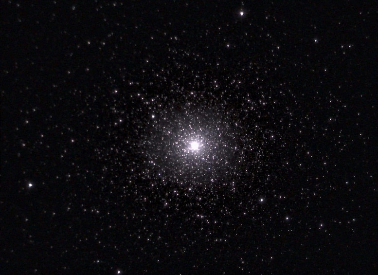 A starry night sky with a dense cluster of stars and a bright central star. 2
