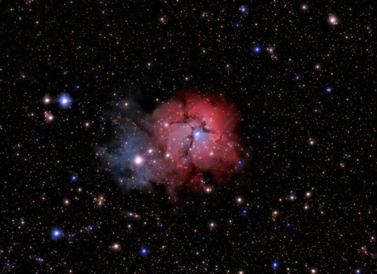 A starry night sky with a prominent nebula and several bright stars. 5
