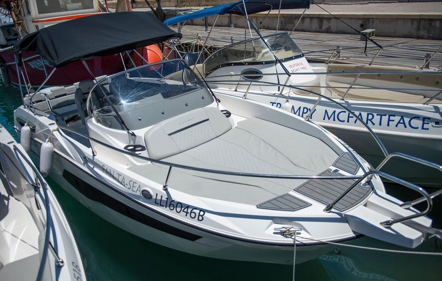 A white motorboat named 'FALINTA-SEA' docked at a marina. 5