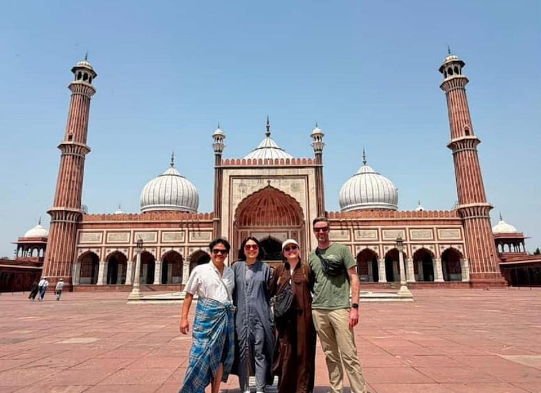 A group of people in front of a large historical building with domes and minarets. 4