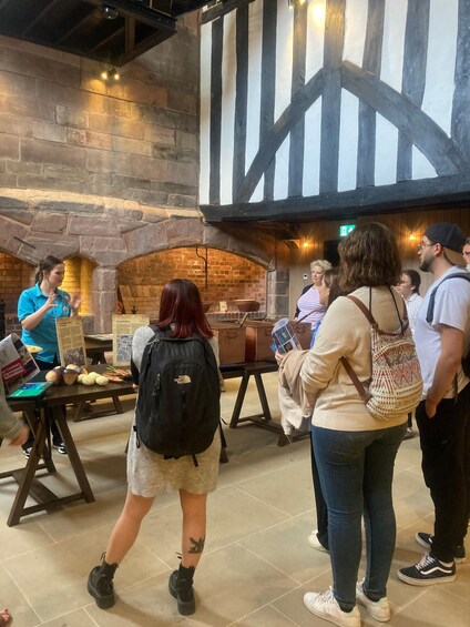 A group of people at a food market with a brick oven in the background. 4