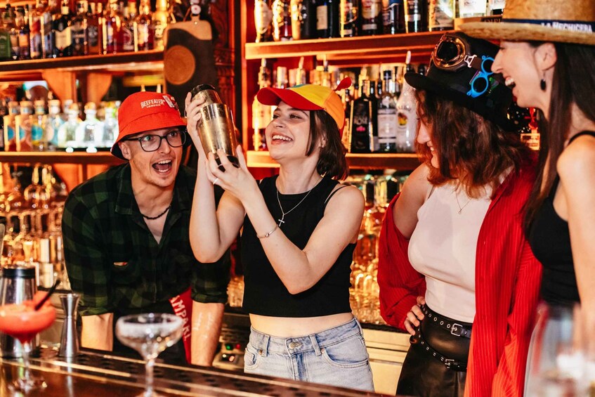 A bar with people, bottles, and a cocktail shaker. 1