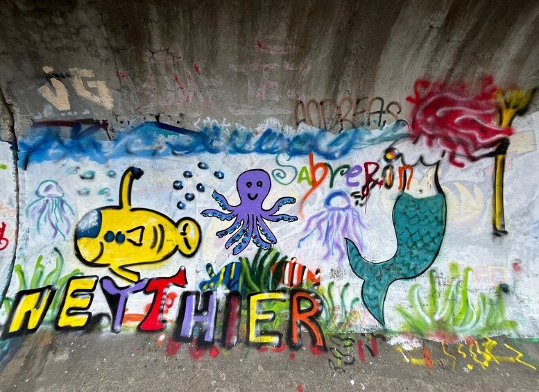 A graffiti mural with colorful sea creatures and the word 'NEITHER' prominently displayed. 5