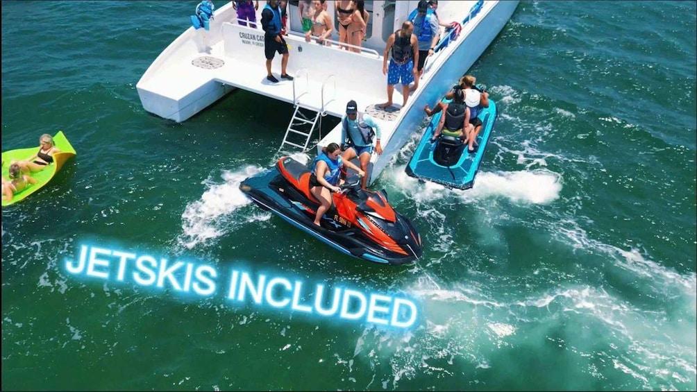 A jet ski on the water with people on a boat and a green inflatable in the background. 5