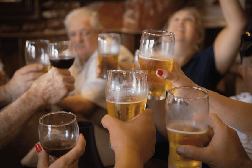 A group of people toasting with beer glasses. 4