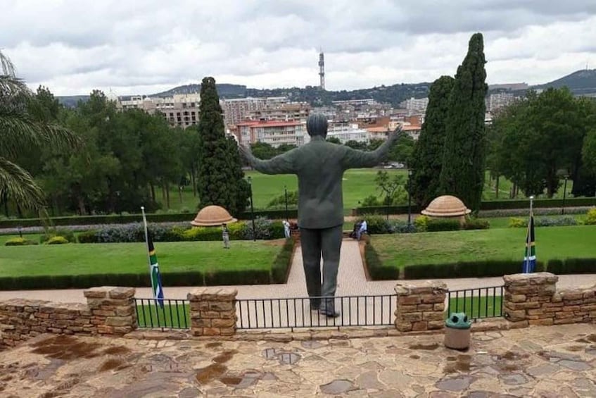A statue of a man with outstretched arms overlooking a cityscape. 3