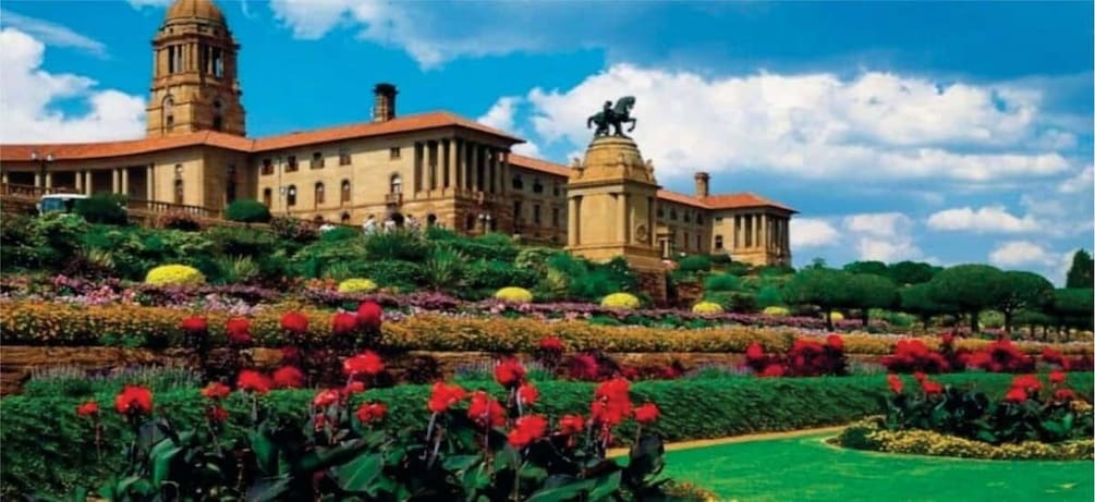 A large building with a dome and a statue in front. 4