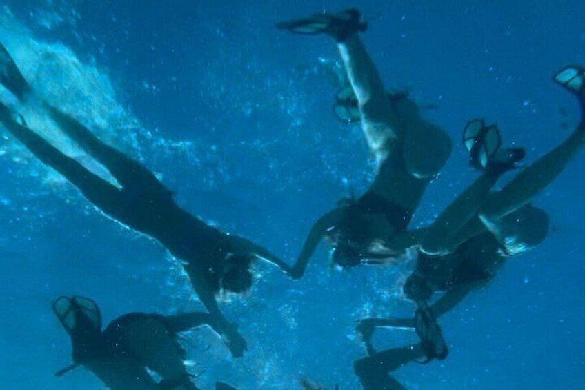 A diver with fins and a mask underwater. 2