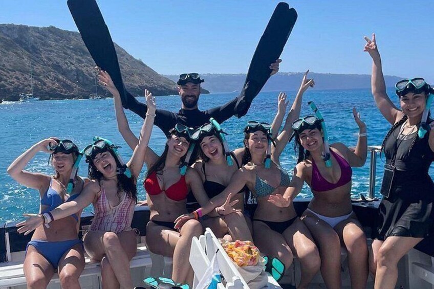 A group of people on a boat, wearing snorkeling gear, with a mountainous landscape in the background. 3